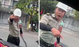 Hai người mặc đồ bảo vệ, cầm hung khí đe dọa tài xế tại TPHCM