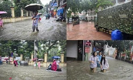Thủ đô ngập lụt chưa từng có: Quân đội điều xe cứu trợ, phụ huynh bì bõm cõng con tan trường
