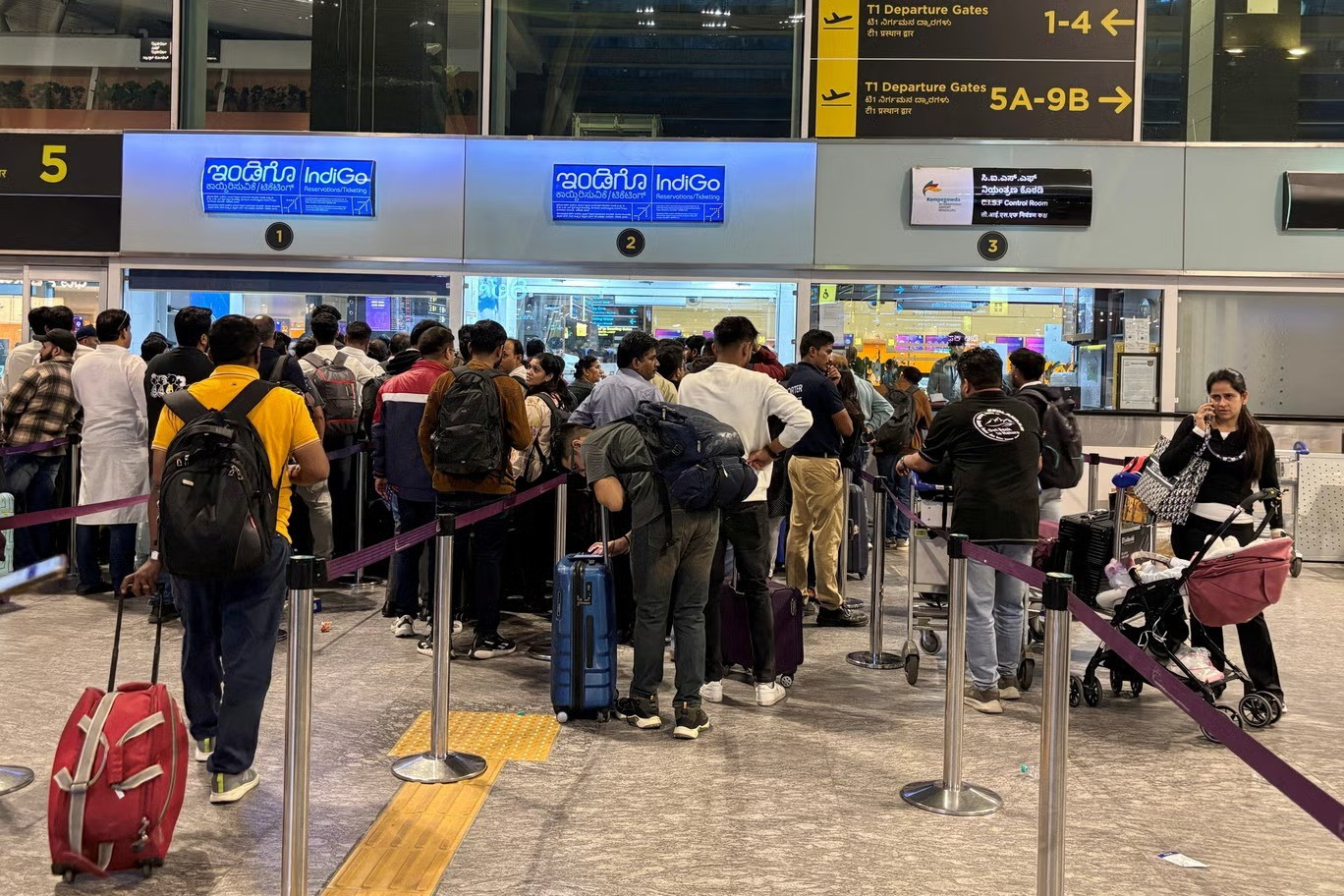 file-photo-travelers-wait-in-queues-at-indigo-ticketing-kiosks-to-reschedule-their-flights-at-kempeg-11zon.jpg