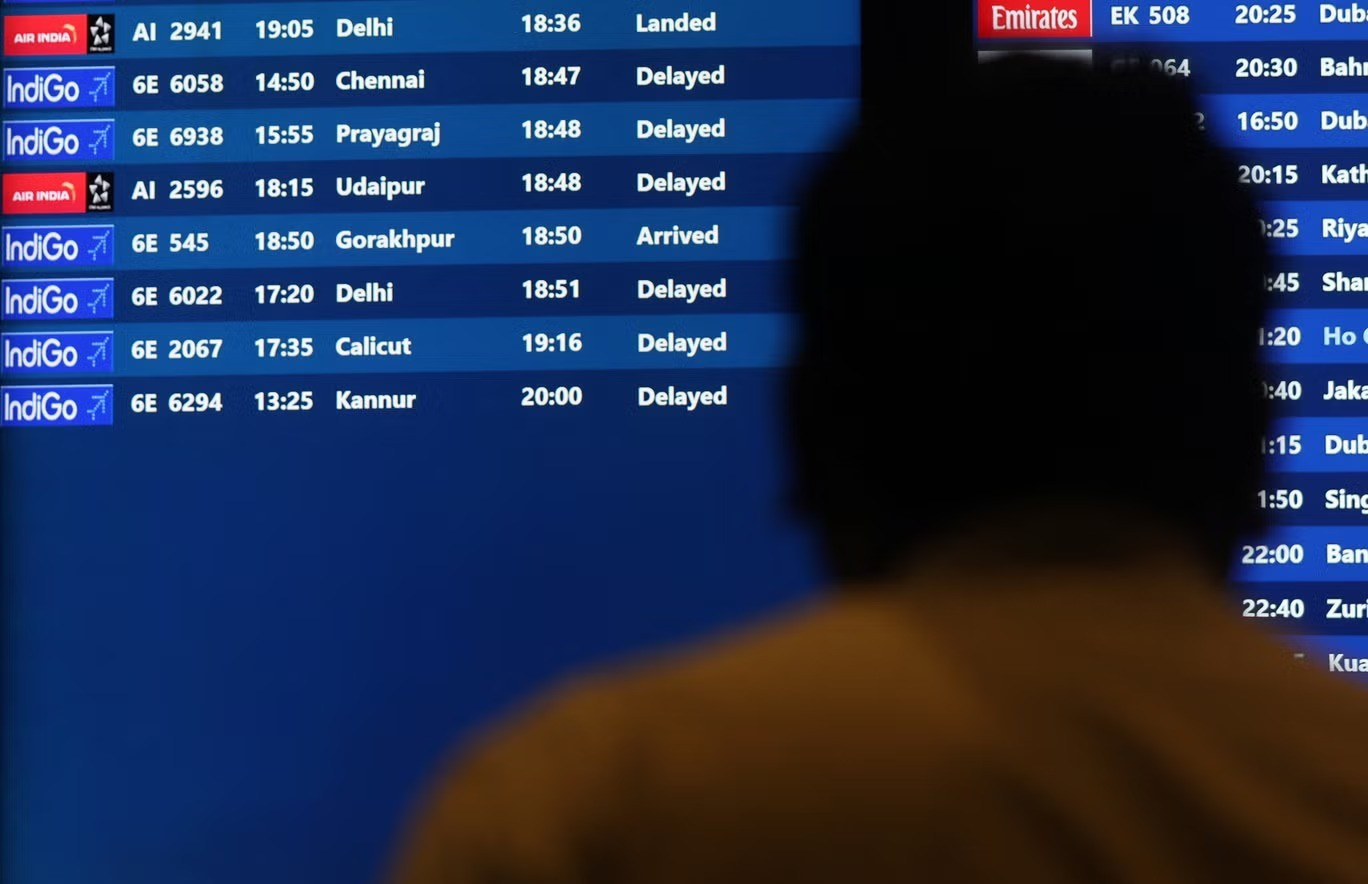 a-man-looks-at-a-fight-schedule-screen-displaying-several-delayed-flights-by-indigo-airlines-at-the-11zon.jpg