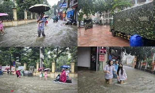 Thủ đô ngập lụt chưa từng có: Quân đội điều xe cứu trợ, phụ huynh bì bõm cõng con tan trường