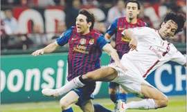 Hàng thủ AC Milan đã gây nhiều khó khăn cho Messi và đồng đội Ảnh: Getty Images