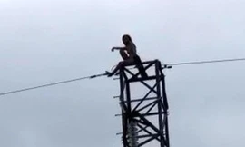 Cảnh sát giải cứu cô gái khỏa thân ngồi trên cột điện cao thế