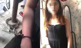 Hình ảnh cô gái bị còng tay vào song cửa sổ phòng trọ. Ảnh: Cắt từ video