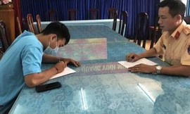 Nằm trên yên điều khiển xe máy, thanh niên bị phạt 7 triệu đồng