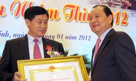 Ủy viên Bộ Chính trị, Bí thư Thành ủy TPHCM Lê Thanh Hải trao Huân chương lao động hạng hai cho ông Johnathan Hạnh Nguyễn. Ảnh: Hữu Vinh