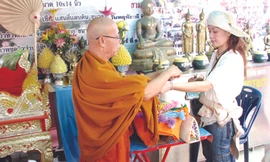 Nghi lễ rảy nước và buộc chỉ cầu may ở Tam giác Vàng