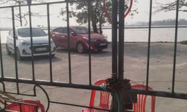 Hai chiếc xe của cán bộ Trung tâm phát triển quỹ đất huyện Thanh Liêm bị giữ lại trong nhà văn hóa thôn Ô Cách. Ảnh: Dân trí