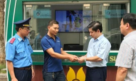 Đại diện Đội TTGT quận Ba Đình chứng kiến tài xế vi phạm trao tiền thu cao trả lại hành khách ​