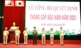 Trung tướng Nguyễn Hải Trung Giám đốc Công an TP Hà Nội trao quyết định thăng cấp bậc hàm cho trưởng các phòng, trưởng Công an các quận, huyện. 