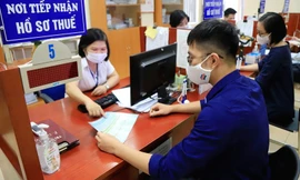 Người dân làm thủ tục tại cơ quan thuế. (Ảnh CP). 