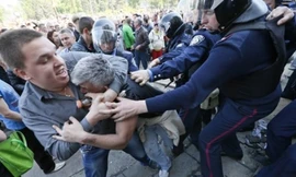 Cảnh sát Ukraina cố gắng tách hai người khi họ đánh nhau tại thành phố Odessa hôm 3/5. Một người ủng hộ chính phủ Ukraina, còn người kia ủng hộ Nga. Ảnh: Reuters