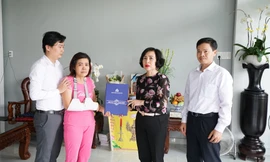 Đại diện Ban giám hiệu trường ĐH Hoa Sen trao bang tốt nghiệp cho bà Liên (áo hồng) mẹ của nam sinh Hải Nguyên