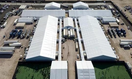 Những người di cư bị bắt vàđược nhìn thấy bên ngoài một trung tâm giam giữ sau khi cố gắng xâm nhập vào Mỹ, ở Donna, Texas.