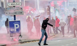 Một người biểu tình ném bom xăng vào cảnh sát sau khi cuộc biểu tình biến thành đụng độ. Ảnh: AFP 