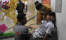 Nạn nhân bị ngộ độc đang được sơ cứu tại chỗ. Ảnh: Minh Sơn/Vietnam+.