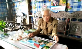 Ông Bảo xem lại những hình ảnh kỷ niệm thời quân ngũ.