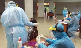 Lấy mẫu xét nghiệm người tiếp xúc với cá nghi mắc COVID-19 (ảnh: HCDC)