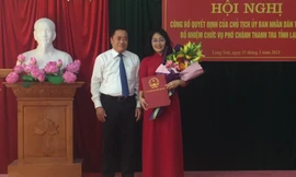 Bà Nguyễn Mai Loan (bìa phải) nhận quyết định và hoa của lãnh đạo UBND tỉnh Lạng Sơn .Ảnh: Duy Chiến 