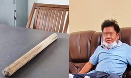 Ông Nguyễn Văn Xuân, người tham gia đánh ông Phạm Trọng Nghị, bên cạnh là thanh gậy gỗ gây án. Ảnh: Công an cung cấp