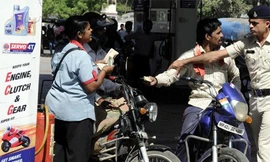 Người đi xe máy không được mua xăng nếu không đội mũ bảo hiểm