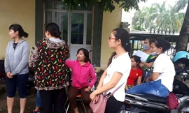 Giáo viên hợp đồng tập trung cạnh UBND huyện Thanh Oai để chờ lời giải thích thỏa đáng từ lãnh đạo huyện. Ảnh: Đình Tuệ/ Lao Động