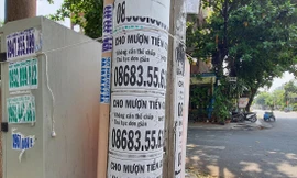 Thông tin cho vay tiền được dán đầy trên cột điện. Ảnh: Hoàng Thuận