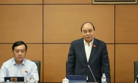 Chủ tịch nước Nguyễn Xuân Phúc bày tỏ lo ngại lạm phát gây thêm khó khăn cho người dân, doanh nghiệp. Ảnh: Nhật Minh