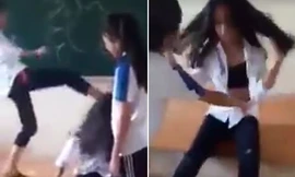 Năm nữ sinh lớp 7 trường THCS Trường Yên (Chương Mỹ, Hà Nội) đã đánh hội đồng, phanh áo một bạn nữ tại lớp học. Ảnh cắt từ clip.