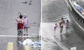 Bố bắt hai con nhỏ đứng tạo dáng giữa siêu bão Mangkhut để chụp ảnh