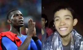 Paul Pogba (trái) và cầu thủ nhí Thái Lan (phải). 