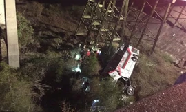 Chiếc xe buýt lật nghiêng dưới chân vách núi. Ảnh: Twitter