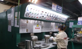 Công nhân nhà máy Sunhouse ở Quốc Oai (Hà Nội) đang sản xuất lòng nồi cơm điện