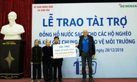 Ông Taco Zantinge, Giám đốc Nhà máy bia HEINEKEN tại Hà Nội, trao tặng khoản tài trợ trị giá 170 triệu đồng cho đại diện UBND và các hộ dân xã Vân Tảo