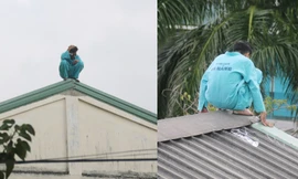 Người đàn ông ngồi trên nóc nhà E bệnh viện Đà Nẵng. Ảnh: Nguyễn Thành