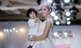 Diễm Châu mặc váy cưới đưa con trai 13 tháng tuổi lên sàn diễn