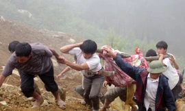 Lực lượng cứu hộ vận chuyển thi thể nạn nhân khỏi khu vực sạt lở sáng 8-9