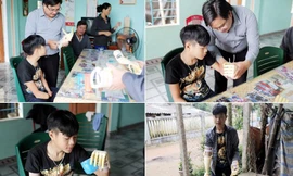 ThS. Đặng Ngọc Sỹ (đứng) lắp Cánh tay “Robot”cho em Phan Trọng Hiếu để em có thể uống nước, đi xe đạp.