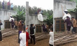 Cô gái mặc váy cưới leo thang vào nhà gây xôn xao cộng đồng mạng ngày hôm nay.