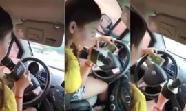 Cô gái vừa lái xe, vừa hát và chơi game. Ảnh cắt từ clip