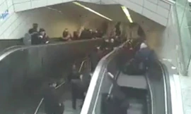 Người đàn ông cố bám vào thành thang cuốn nhưng vẫn bị "nuốt chửng". Ảnh cắt từ video