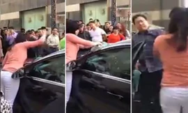 Đập cửa kính ôtô lôi chồng ra bạt tai giữa đường