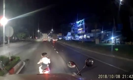 Hai người đi xe máy không đội mũ bảo hiểm tạt đầu container.