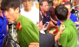 Người mặc áo giống quân phục công an bị vây đánh. Ảnh cắt từ clip.