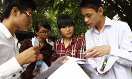 Thí sinh xem lại đề thi sau giờ làm bài môn Hóa học sáng 5/7. Ảnh: Như Ý