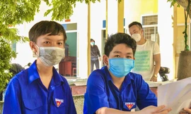 Em Nguyễn Anh Kiệt 14 tuổi và Huỳnh Ngọc Ánh Quốc 12 tuổi (từ trái sang) cùng tình nguyện tham gia chống dịch trong khu cách ly