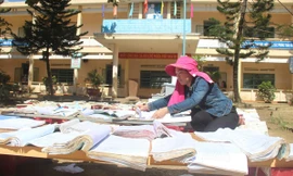 Thầy cô phơi sách vở bị nước mưa dầm ướt.