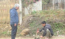 Bác sỹ Đại (bìa trái) và người dân làng Khuổi Mươi thắp nhang tưởng nhớ đến các chiến sỹ áo trắng đã hy sinh vì quê hương (ảnh chụp chiều ngày 16/2/2016). Ảnh: Duy Chiến