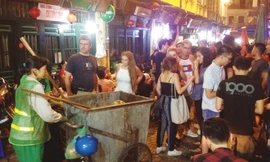 Một công nhân vệ sinh đi thu rác ở phố Tạ Hiện lúc 23h26 ngày 26/8. Ảnh: Trường Phong