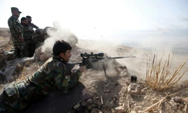 Một chiến binh người Kurd xả súng về phía IS tại thị trấn Naweran, gần Mosul vào ngày 23/10.